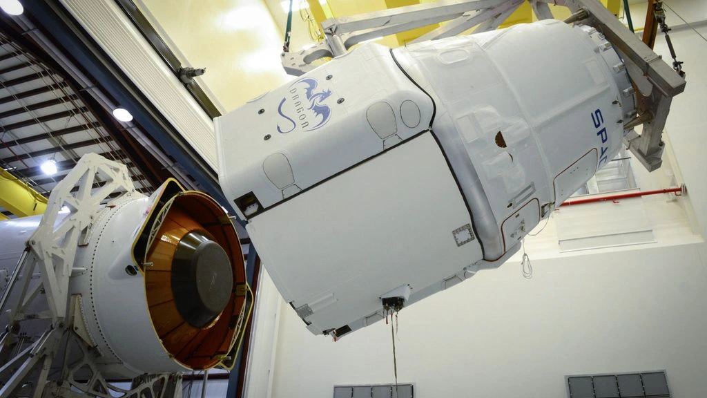 A half-fairing being mated to a heavy-lift payload adapter inside an integration hangar